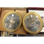 A pair of gilt framed oval coloured engravings of ladies.
