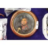 A small circular portrait of a man with a pipe and flagon of foaming ale (lid of a papier mache