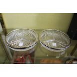 A pair of moulded glass hors d'oeuvres dishes with plated rims.
