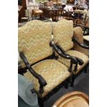 A near pair of open armchairs with carved ebonised frames.