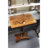 A 19th century rosewood rectangular occasional table on turned column support with platform base.