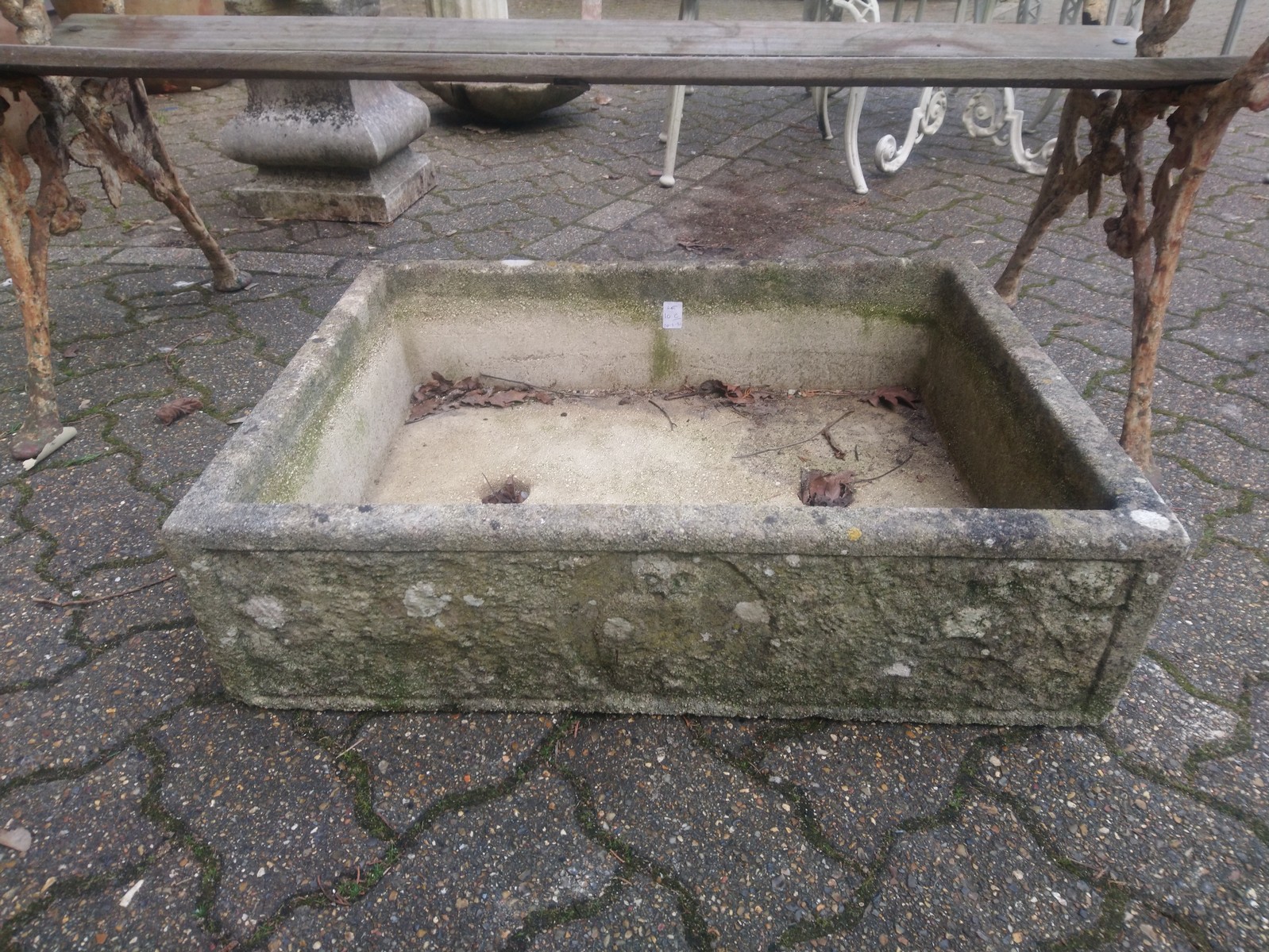 A reconstituted stone rectangular garden planter.