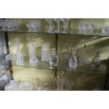 A good collection of cut glass decanters.