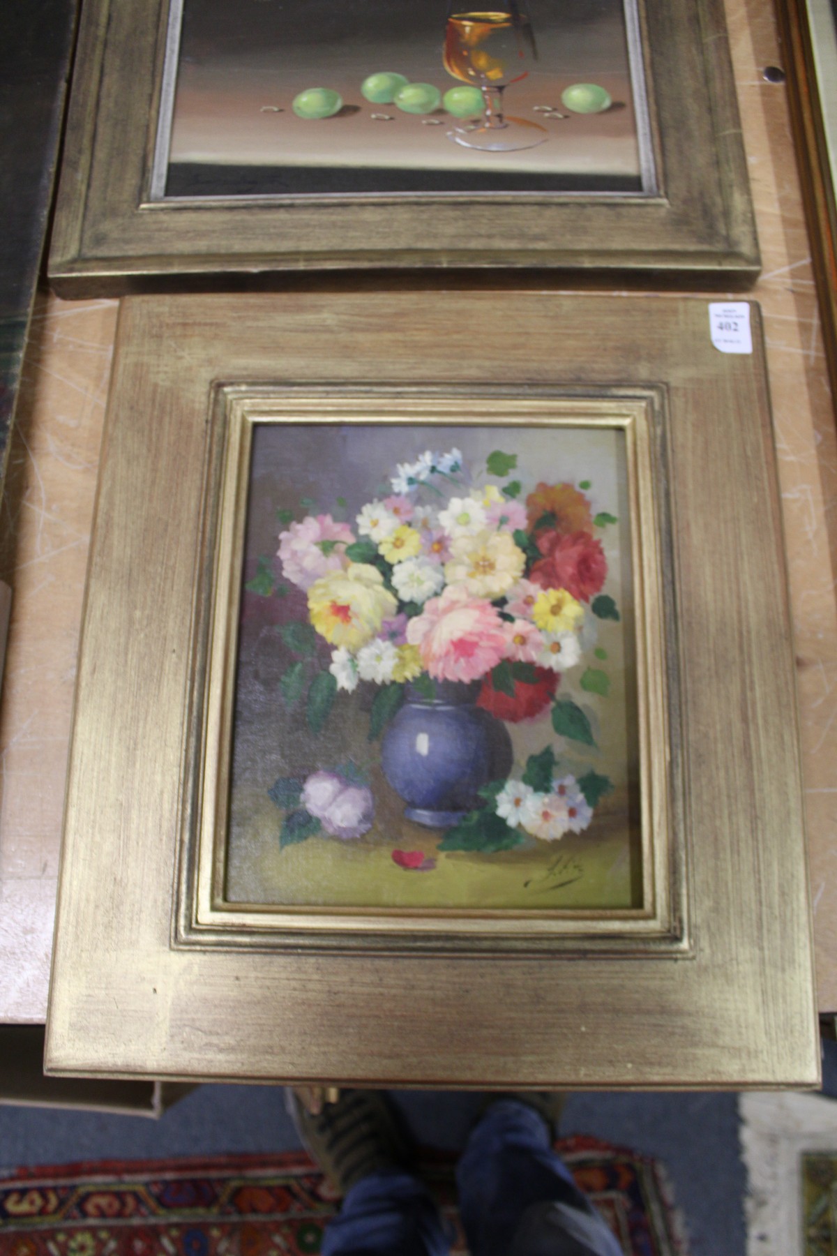 A still life of flowers in a vase, oil on board, in a decorative gilt frame.