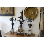 A late 19th century French clock garniture with figural mount.