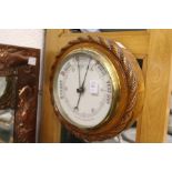 A Victorian oak framed aneroid barometer.