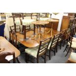 A good George III design mahogany twin pillar extending dining table with one leaf.