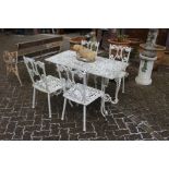 A white painted cast aluminium rectangular patio table and four chairs.