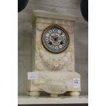 A carved alabaster mantle clock with Sevres style porcelain dial (some losses).