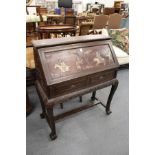 A Chinese hardwood bureau with carved decoration, the fall flap inlaid with hardstones depicting