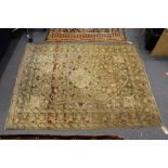 A Persian Tabriz rug, beige ground with floral decoration.