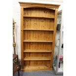 A tall pine open book case.