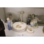 A small group of decorative figurines and other china.