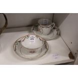 A Chinese export floral decorated tea bowl and saucer with matching cup and saucer.