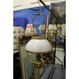 A ship's hanging brass and opaque glass oil lamp.