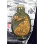 A Chinese carved jade snuff bottle.