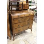 A walnut chest of drawers.