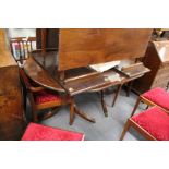 A Regency style mahogany twin pillar dining table with two leaves.