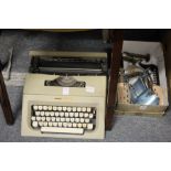 An Olivetti Lettera 25 typewriter and a box of shoe trees.