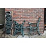 Three pairs of cast metal bench ends together with a seat and a back from one bench.