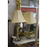 A pair of ornate cast metal table lamps.