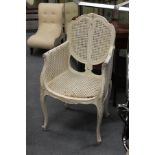 A French style white painted Bergere armchair (AF).