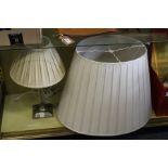 A table lamp and a large lampshade.