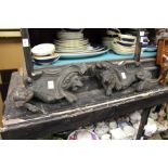 A pair of cast metal lion shaped fire dogs.