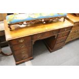 A walnut pedestal desk.