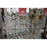 A shelf of cut glassware to include decanters, vases etc.