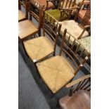 A pair of rush seated spindle back occasional chairs.