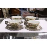 A set of four Chinese famille rose porcelan and silver mounted cups and saucers.