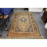 A Persian Shiraz rug, beige ground with stylized decoration.