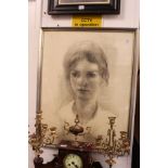 A portrait bust of a young girl, charcoal, signed and dated.