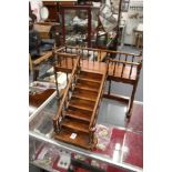 A miniature mahogany set of steps leading to a balcony.