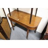 A mahogany D-shaped side table on turned legs.