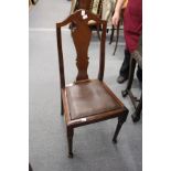 A set of four mahogany high back dining chairs.
