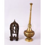 AN INDIAN BRASS ROSEWATER SPRINKLER, together with a cast brass figure group, 27cm and 15cm.