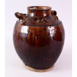 A CHINESE TREACE GLAZED POTTERY EWER, possibly Song dynasty, with moulded handle and spout, 26cm.