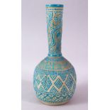 AN UNUSUAL ISLAMIC POTTERY VASE with turquoise beaded and calligraphic decoration, 27cm high.