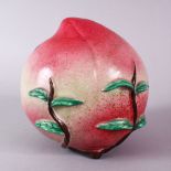AN UNUSUAL 19TH CENTURY OR EARLIER CHINESE FAMILLE ROSE PORCELAIN MODEL OF A PEACH, the peach with a