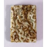 A 19TH CENTURY SPECKLED JADE RECTANGLAR TABLET, carved with scrolls, 6.5cm x 4.5cm.