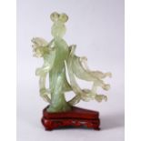 A 19TH / 20TH CENTURY CHINESE CARVED JADE FIGURE OF GUANYIN, upon a carved wooden base, 16cm x 11cm