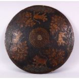 A FINE 18TH/19TH CENTURY INDIAN PAINTED LACQUER LEATHER SHIELD, decorated with a band of tigers,