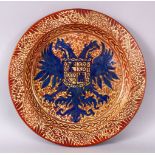 A ISLAMIC HISPANO MORESQUE LUSTRE CIRCULAR DISH, the centre unusually painted with an armorial crest