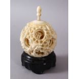 A 19TH CENTURY CHINESE CANTON CARVED IVORY PUZZLE BALL, carved with scenes of a dragon with its