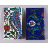 TWO IZNIK DECORATED PORCELAIN FRAGMENT TILES, one with ablue ground, the other with white, both with