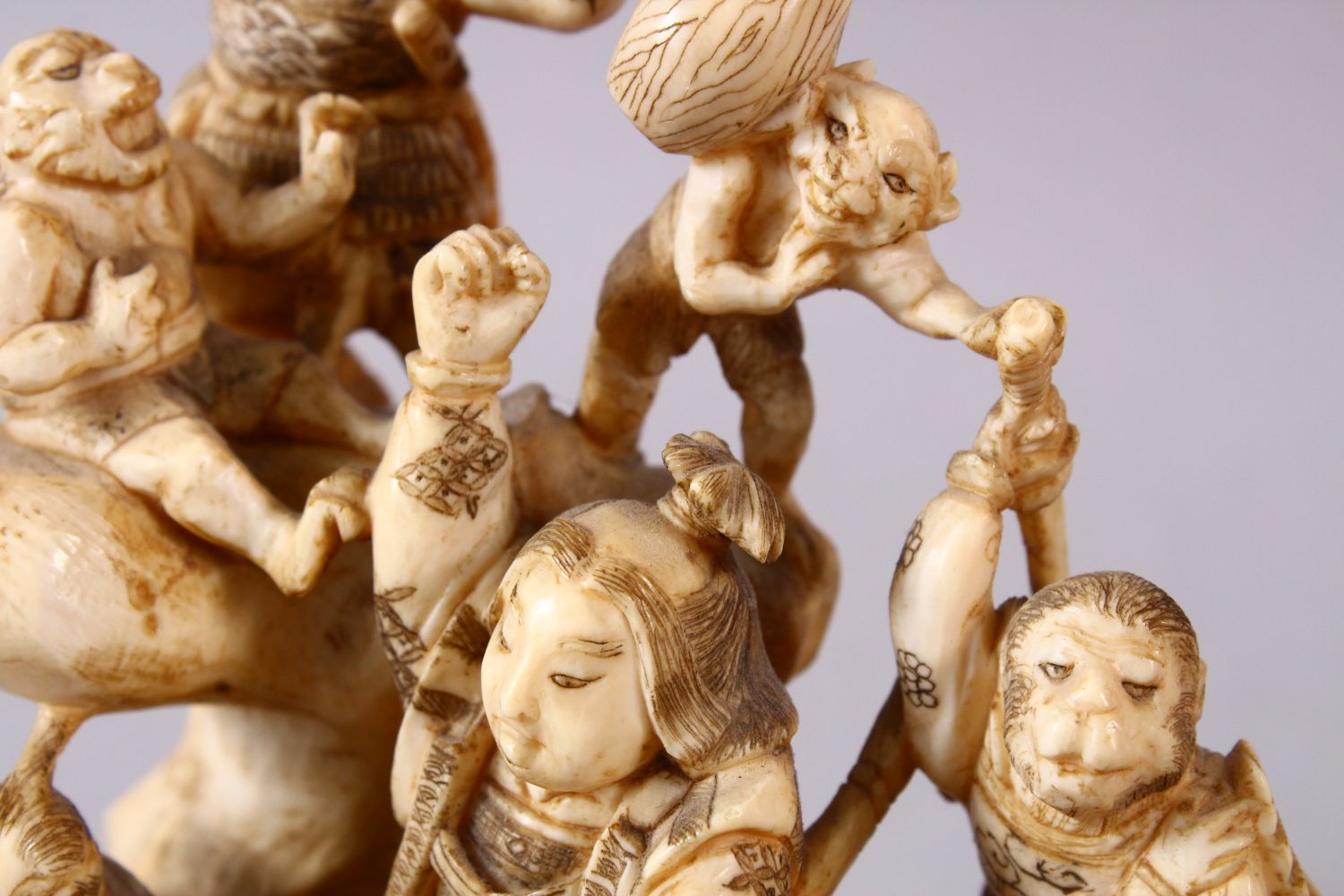 A JAPANESE MEIJI PERIOD CARVED IVORY OKIMONO GROUP - depicting figures attacking oni demons, one dog - Image 8 of 14