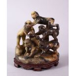 A 20TH CENTURY CHINESE CARVED SOAPSTONE MONKEY GROUP, carved with five monkeys climbing upon one and