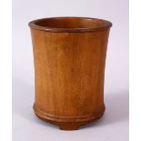 A PLAIN 18TH CENTURY CHINESE BRUSH POT, on three bracket feet, 11cm high.